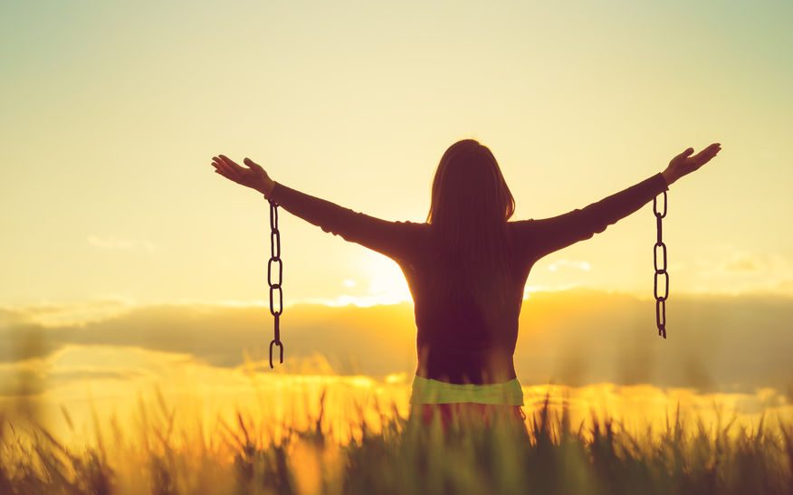 woman arms up broken chains